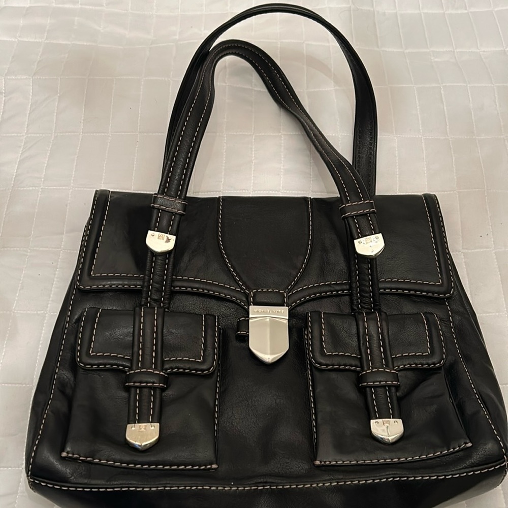 Michael Kors black leather bag. Silver embellishments and off white stitching.